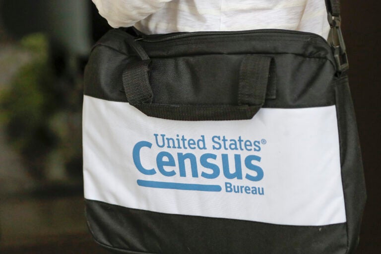 A U.S. Census Bureau worker carries a briefcase while knocking on the door of a home in August in Winter Park, Fla. A U.S. Census Bureau worker carries a briefcase while knocking on the door of a home in August in Winter Park, Fla. (John Raoux/AP)