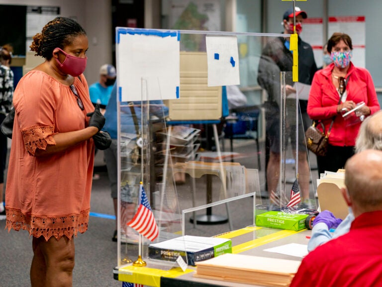 A voter waits to be handed her ballot