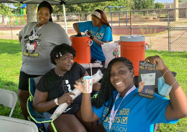 This summer, Nyzia Easterling, left; and teen census workers, from left to right; Eternity Easterling, 14; Janiayah Williams, 16; and Shayla Ingram, 16; pose for a picture while manning a table in a Camden park to promote census awareness.