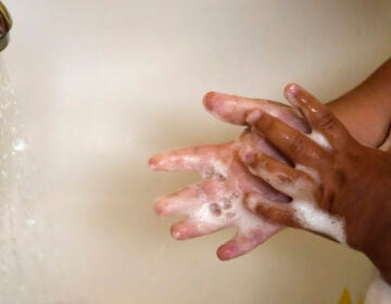 A child washes her hands at a day care center in Connecticut