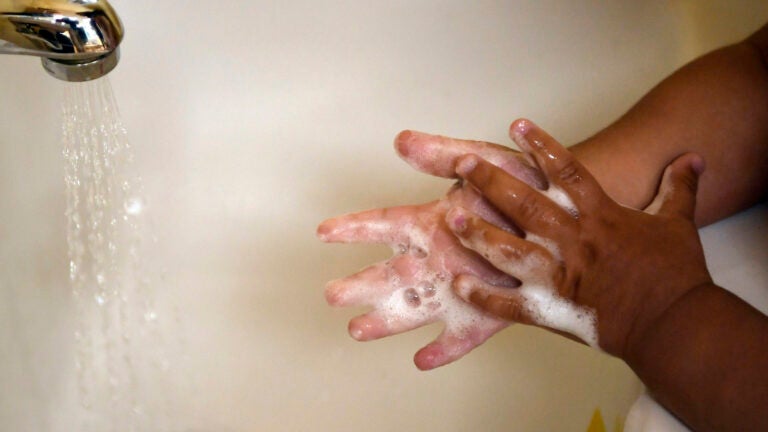 A child washes her hands at a day care center in Connecticut