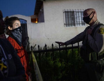 A protester talks with a deputy of the Los Angeles Sheriff's Department during demonstrations following the death of a Black man identified as Dijon Kizzee on Monday in Los Angeles. (Christian Monterrosa/AP)