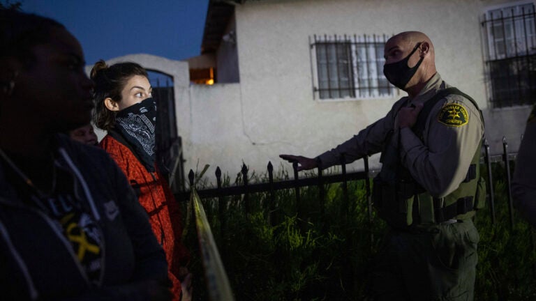 A protester talks with a deputy of the Los Angeles Sheriff's Department during demonstrations following the death of a Black man identified as Dijon Kizzee on Monday in Los Angeles. (Christian Monterrosa/AP)