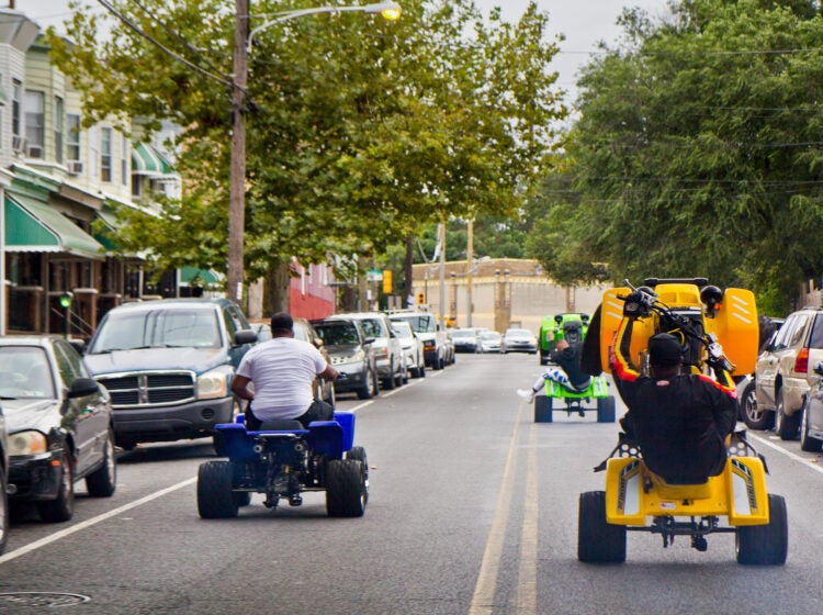 Young people riding ATVs through the streets of Philly. (Kimberly Painter/WHYY)