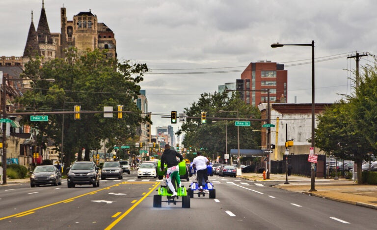 Young people riding ATVs through the streets of Philly. (Kimberly Paynter/WHYY)