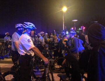 Protests are stopped at South Street Bridge by Philadelphia Police on the second night of protests after a grand jury's decision in the Breonna Taylor case. (Joe Hernandez/WHYY)