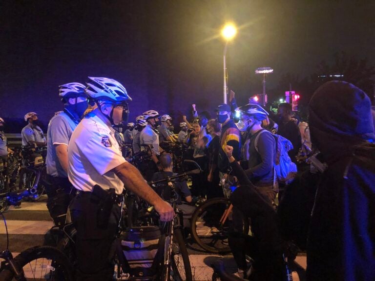 Protests are stopped at South Street Bridge by Philadelphia Police on the second night of protests after a grand jury's decision in the Breonna Taylor case. (Joe Hernandez/WHYY)