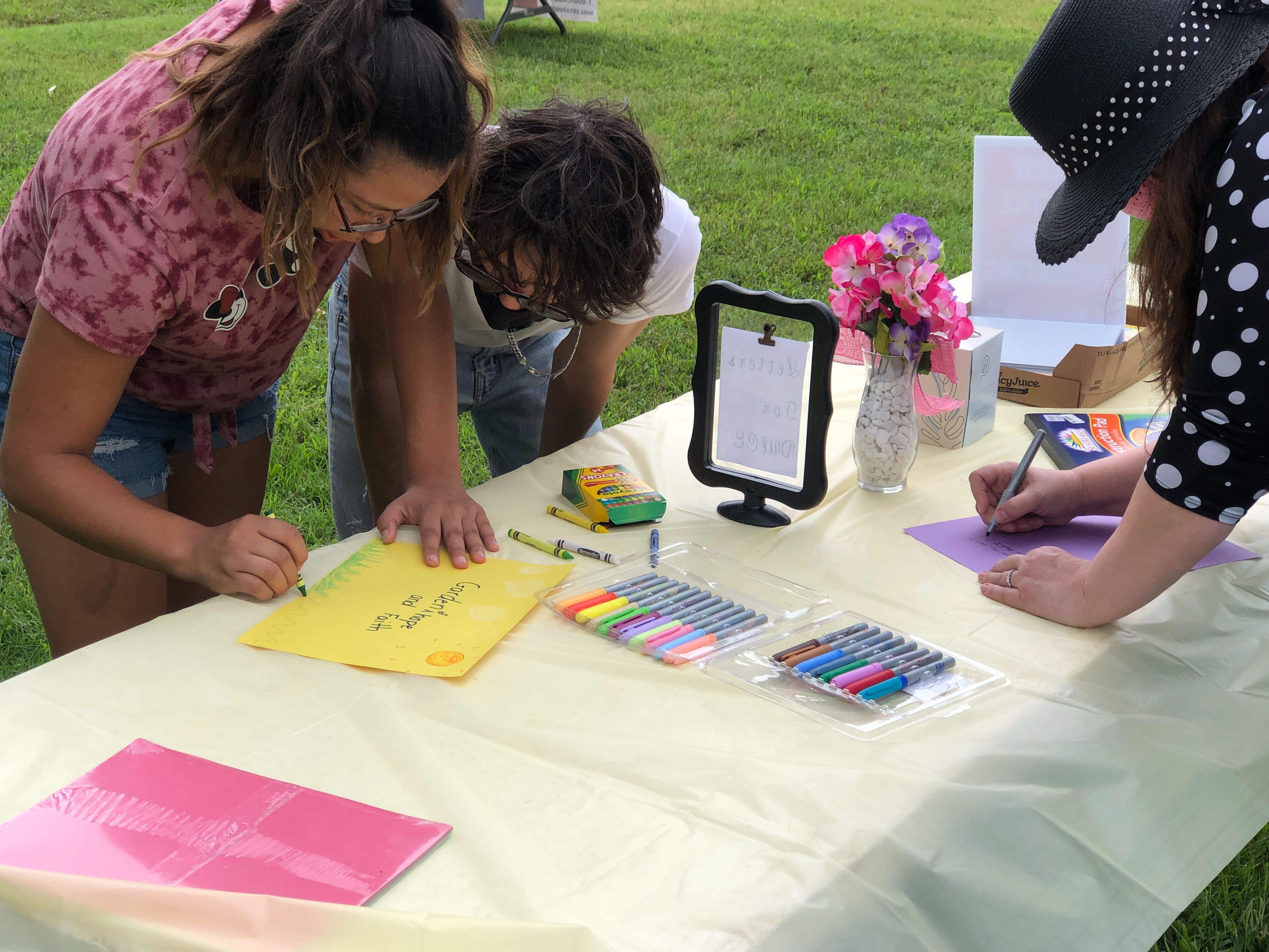 Community members writing letters to Dulce