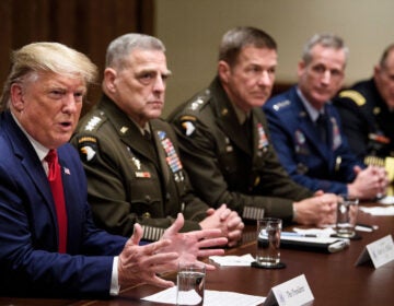 Chairman of the Joint Chiefs of Staff Army Gen. Mark A. Milley (second from left) and others listen as President Trump speaks during a meeting with senior military leaders on Oct. 7, 2019. (Brendan Smialowski/AFP via Getty Images)