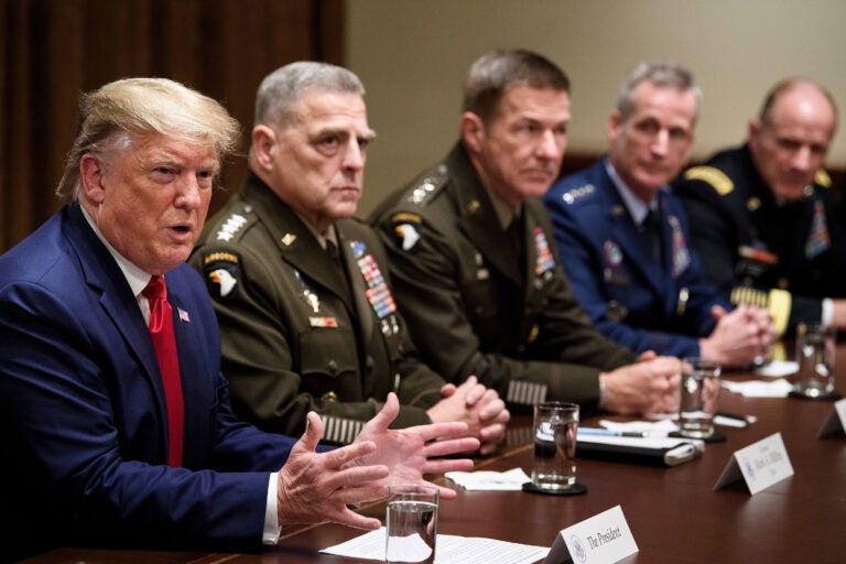 Chairman of the Joint Chiefs of Staff Army Gen. Mark A. Milley (second from left) and others listen as President Trump speaks during a meeting with senior military leaders on Oct. 7, 2019. (Brendan Smialowski/AFP via Getty Images)