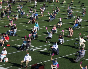 The annual town meeting in North Andover, Mass., which dates back to 1646, was held outside on June 16 on a high school football field to help keep participants a safe distance from each other.
(Jim Davis/The Boston Globe via Getty Images)