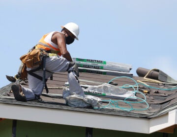 A construction worker roofs an apartment complex in Uniondale, N.Y., on May 27. U.S. employers added fewer jobs last month even as the unemployment rate fell to 8.4%. (Al Bello/Getty Images)