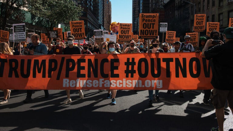 People march during the nationwide protest demanding the end to the Trump administration