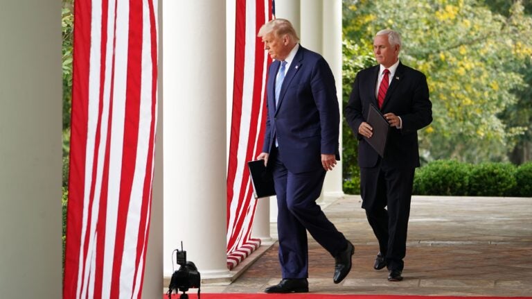 President Trump and Vice President Mike Pence make their way to the Rose Garden to speak on COVID-19 testing at the White House Monday.