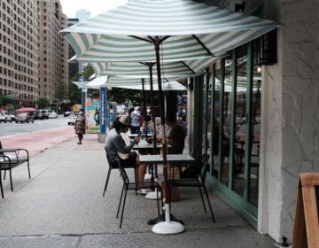 People eat at outside tables in Manhattan on August 31, 2020 in New York City. While New York City restaurants are currently permitted to serve take-out and to offer sidewalk dining, they are not allowed to offer indoor dining due to COVID-19 and there are currently no plans to let them begin indoor dining. (Photo by Spencer Platt/Getty Images)