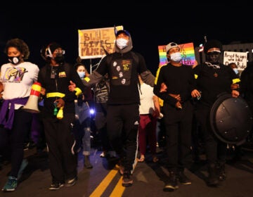 Demonstrators lock arms as they march for Daniel Prude on Friday in Rochester, N.Y. Prude died after being arrested on March 23 by Rochester police officers, who had placed a 