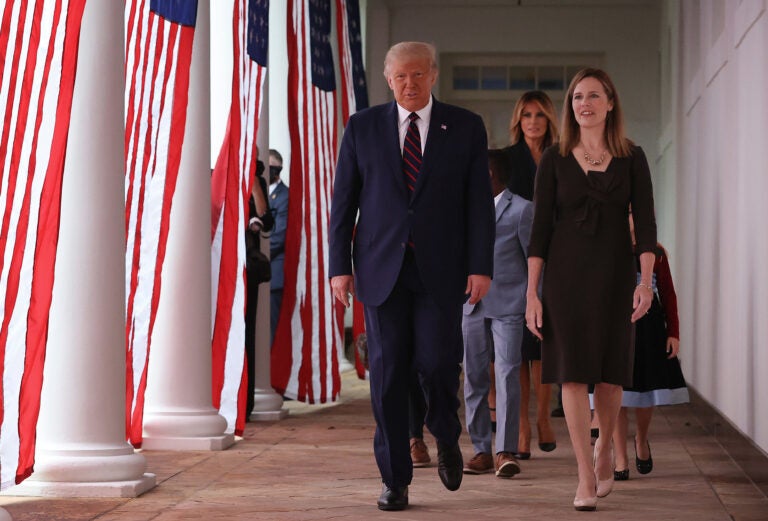 President Trump and Supreme Court nominee Amy Coney Barrett walk along the Rose Garden Colonnade on Saturday. The focus on the court just weeks before the election could help energize conservatives in key states.