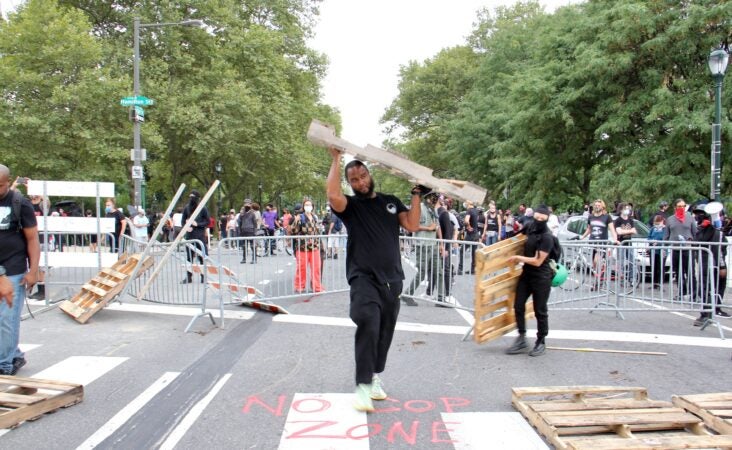 Protesters create a defensive barrier around the homeless encampment