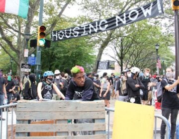 Protesters wait behind blockades to defend the Parkway homeless encampment