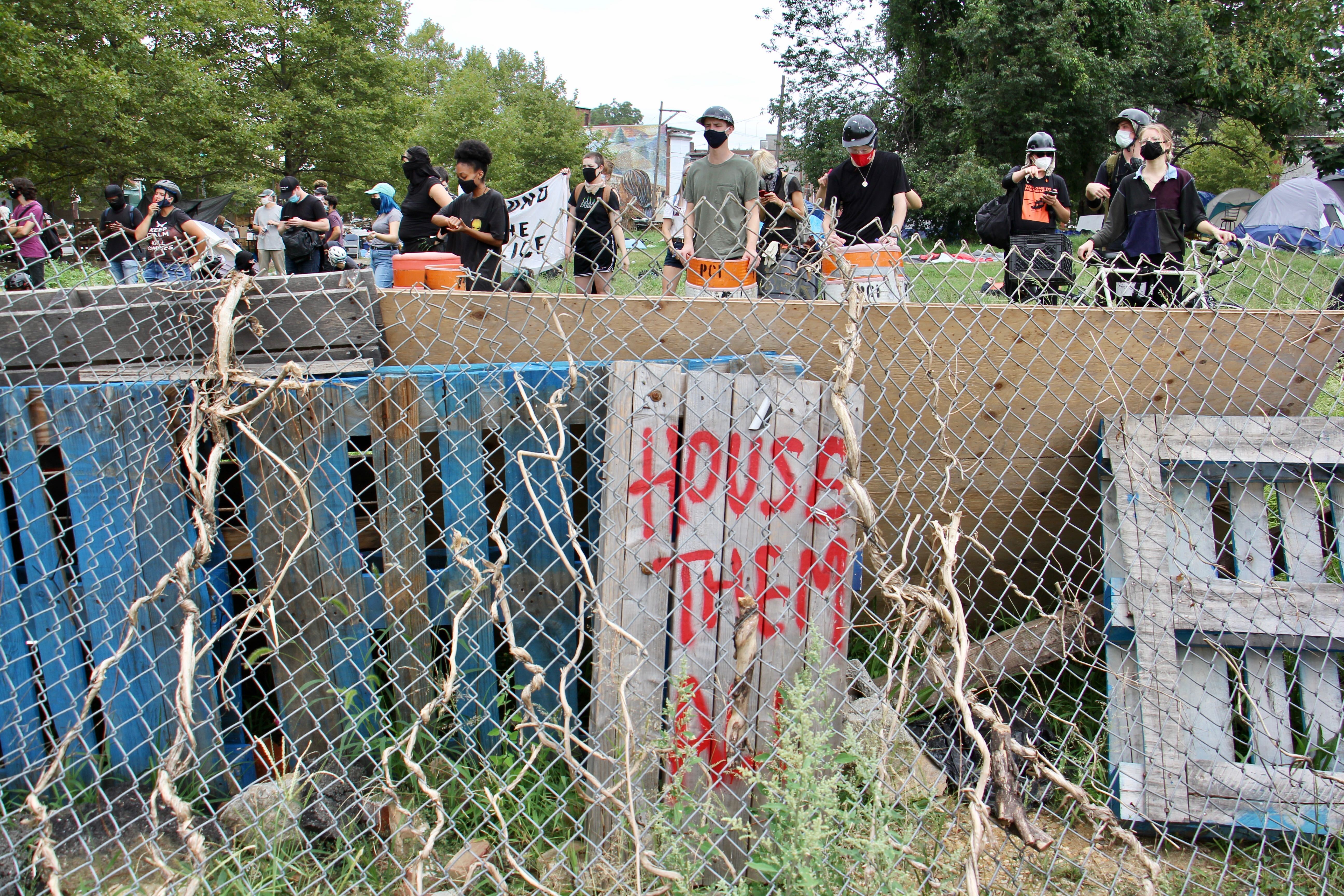 Protesters defend a homeless encampment on Ridge Avenue