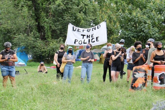 Protesters defend a homeless encampment on Ridge Avenue