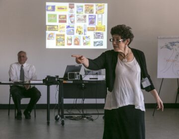 In this Feb. 11, 2015, photo, veteran LAPD officers Don Wynne, left, and Ann Bozzi instruct dozens of unidentified Los Angeles Police Department officers learn to recognize unconscious prejudices and how they can impact behaviors on the street at a class at the Museum of Tolerance in Los Angeles. The department, which expects to send more than 5,000 officers to the museum’s course in the next several years, is working to weave implicit bias lessons into existing training. (AP Photo/Damian Dovarganes)