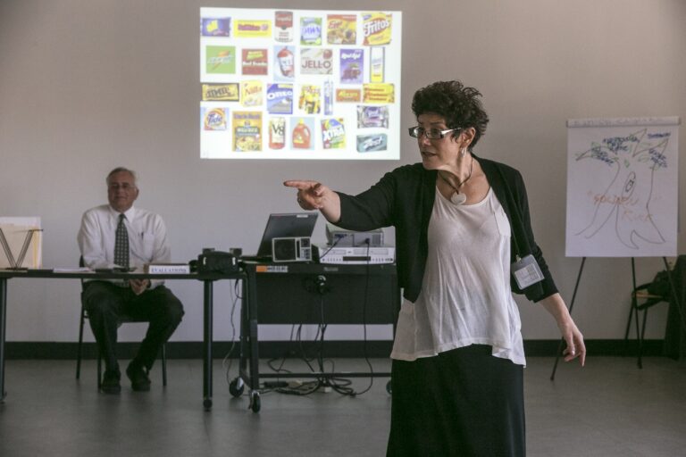 In this Feb. 11, 2015, photo, veteran LAPD officers Don Wynne, left, and Ann Bozzi instruct dozens of unidentified Los Angeles Police Department officers learn to recognize unconscious prejudices and how they can impact behaviors on the street at a class at the Museum of Tolerance in Los Angeles. The department, which expects to send more than 5,000 officers to the museum’s course in the next several years, is working to weave implicit bias lessons into existing training. (AP Photo/Damian Dovarganes)