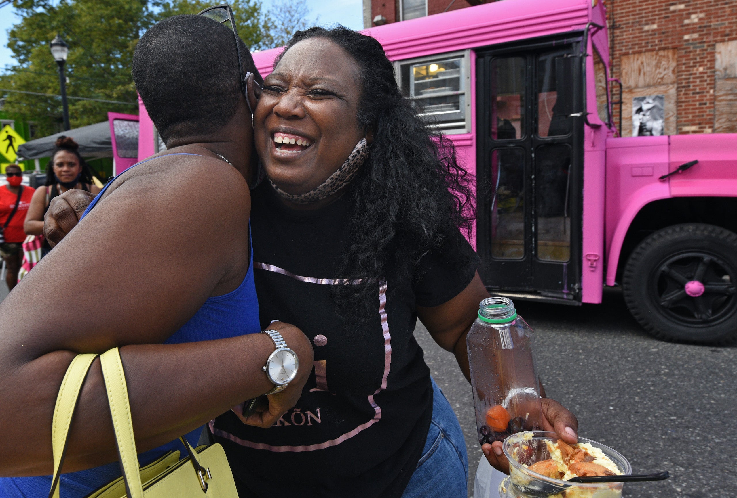 Tawanda Jones gets a hug at Masked Melanin Market