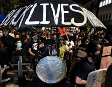 Demonstrators march through the streets in Rochester, N.Y., Friday, Sept. 4, protesting the death of Daniel Prude. Prude apparently stopped breathing as police in Rochester were restraining him in March 2020 and died when he was taken off life support a week later. (Adrian Kraus/AP Photo)