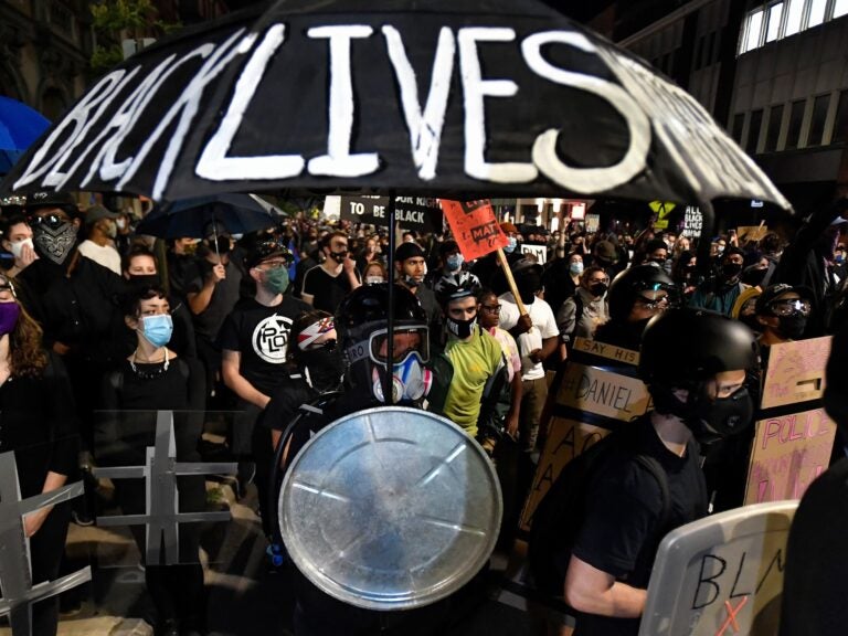 Demonstrators march through the streets in Rochester, N.Y., Friday, Sept. 4, protesting the death of Daniel Prude. Prude apparently stopped breathing as police in Rochester were restraining him in March 2020 and died when he was taken off life support a week later. (Adrian Kraus/AP Photo)