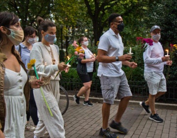 Friends of Sarah Pitt lit candles and carried flowers at Rittenhouse Square park in Philadelphia for a vigil and a march in her honor. (Kimberly Paynter/WHYY)