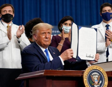 President Trump holds up an executive order after delivering remarks on health care in Charlotte, N.C., on Thursday. (Evan Vucci/AP Photo)