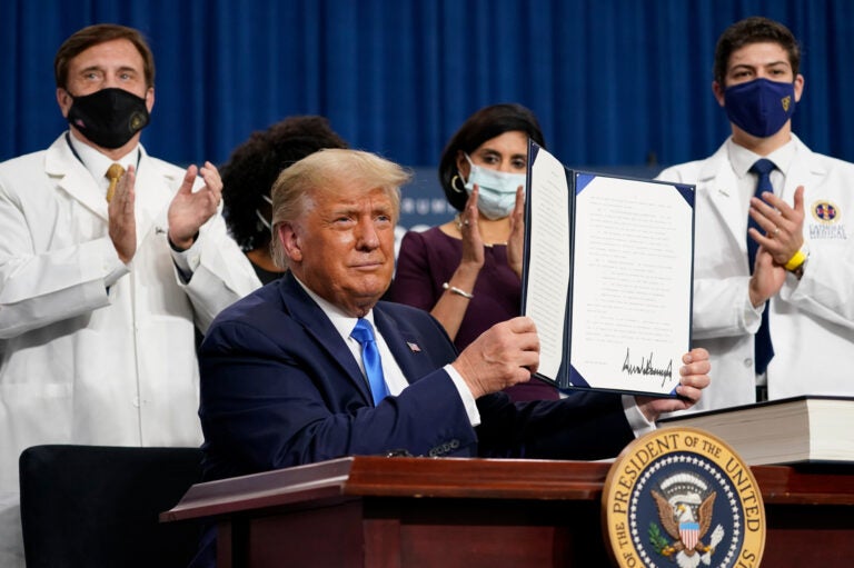 President Trump holds up an executive order after delivering remarks on health care in Charlotte, N.C., on Thursday. (Evan Vucci/AP Photo)