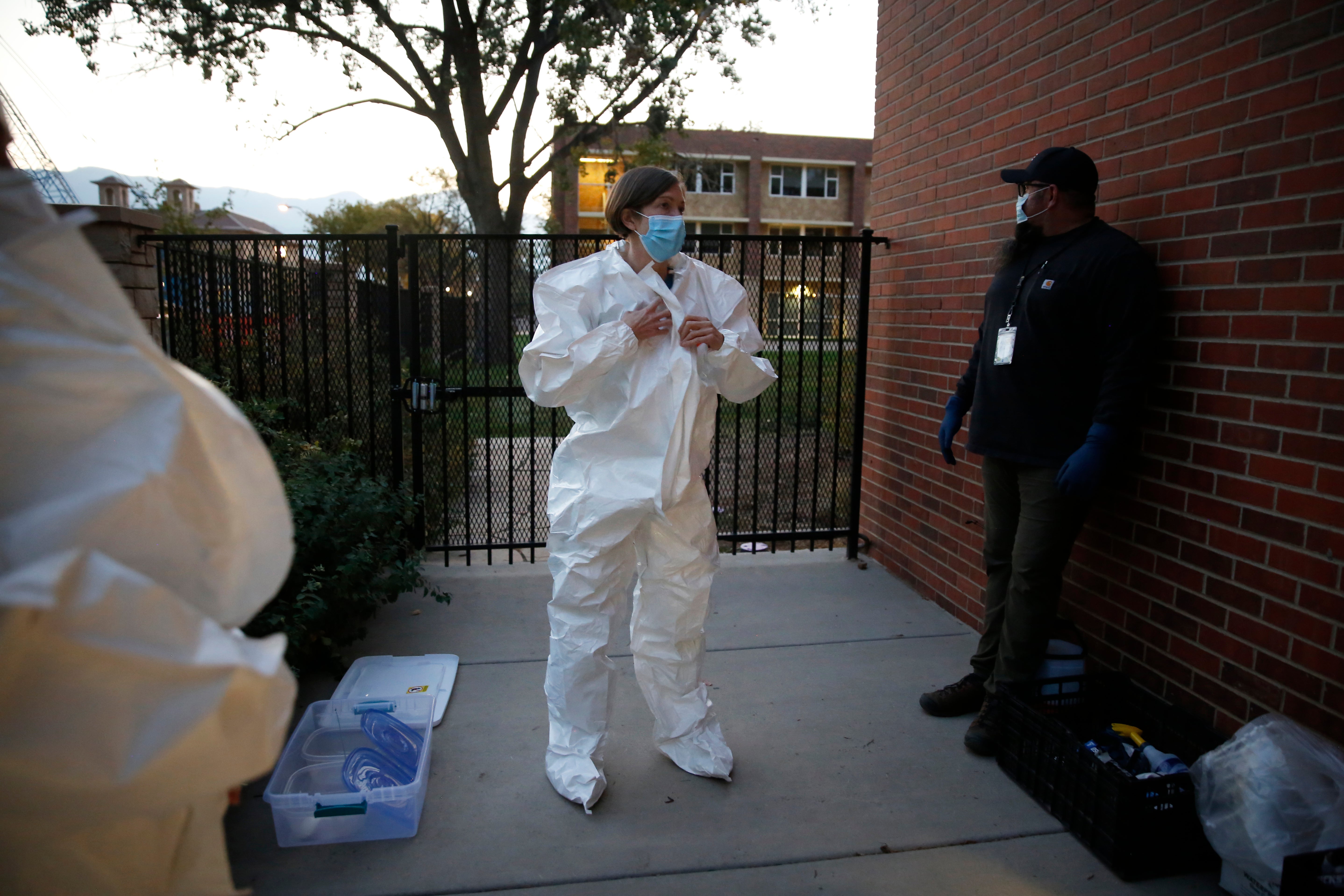 Colorado College mathematics professor Andrea Bruder suits up before descending into the tunnels below South Hall