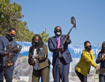 Pa. State Representative Donna Bullock (right), Mosaic Development Partner Leslie Smallwood-Lewis (second from right), PHA CEO Kelvin Jeremiah (center), executive director of the Brewerytown Sharswood Community Civic Association Darnetta Arce (second from left) and Pa. State Senator Sharif Street (left) ceremoniously broke ground on the new Sharswood Ridge development in Philadelphia. (Kimberly Paynter/WHYY)