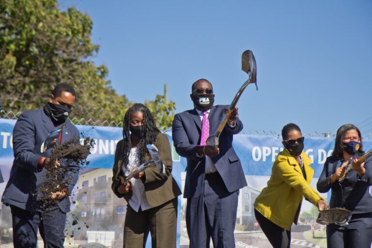 Pa. State Representative Donna Bullock (right), Mosaic Development Partner Leslie Smallwood-Lewis (second from right), PHA CEO Kelvin Jeremiah (center), executive director of the Brewerytown Sharswood Community Civic Association Darnetta Arce (second from left) and Pa. State Senator Sharif Street (left) ceremoniously broke ground on the new Sharswood Ridge development in Philadelphia. (Kimberly Paynter/WHYY)