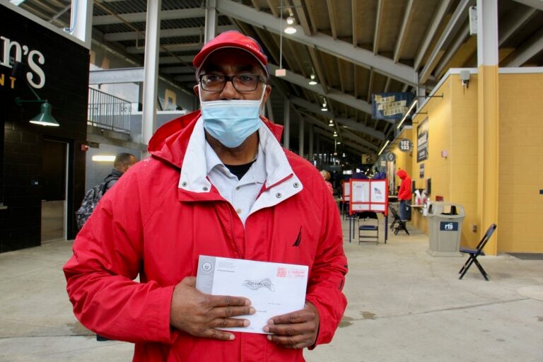 Darryl Turner of Chester, Pa., stops at the pop-up voter service center at Subaru Park to drop off his mail-in ballot. (Emma Lee/WHYY)