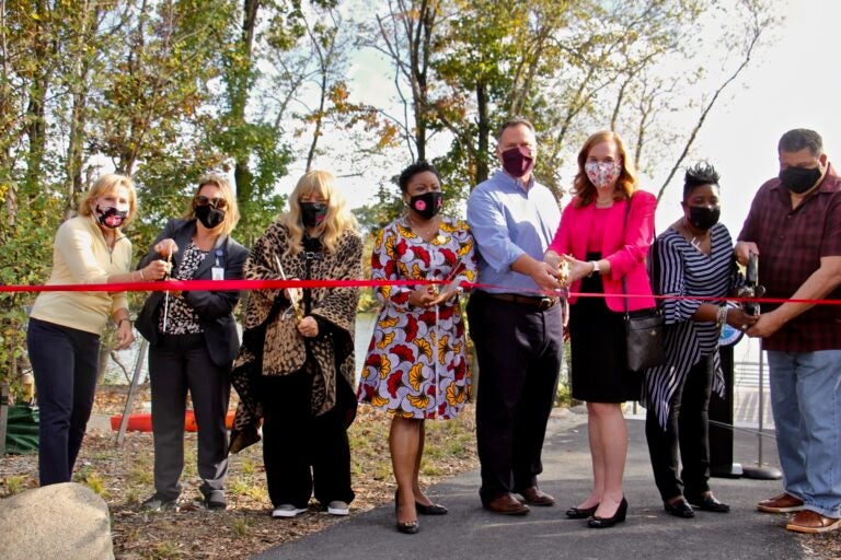 Willingboro Mayor Tiffani Worthy (center) joins local and county officials to cut the ribbon on the township's first county park. (Emma Lee/WHYY)
