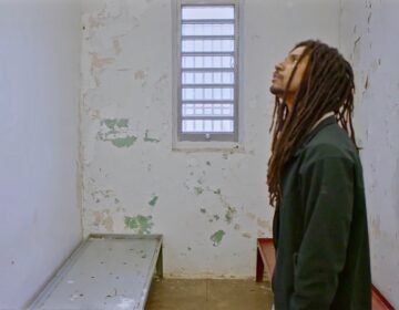 In the new MOVE documentary, '40 Years a Prisoner,' Mike Africa, Jr., visits the prison cell where he was born. (Screenshot from 40 Years a Prisoner)