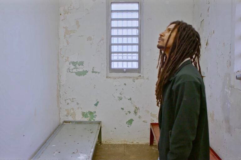 In the new MOVE documentary, '40 Years a Prisoner,' Mike Africa, Jr., visits the prison cell where he was born. (Screenshot from 40 Years a Prisoner)