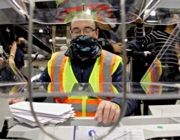 John Hansberry operates an extractor at Philadelphia's ballot counting center