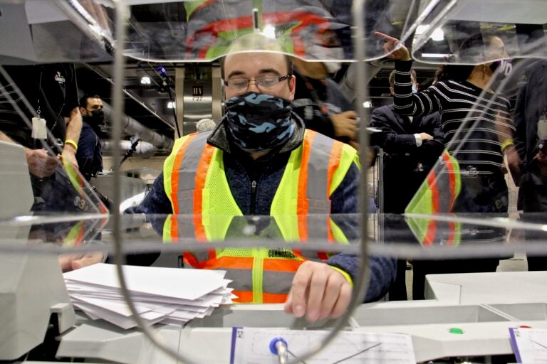 John Hansberry operates an extractor at Philadelphia's ballot counting center