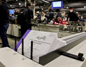 Addresses are printed on outgoing mail-in ballots at the Pennsylvania Convention Center. (Emma Lee/WHYY)