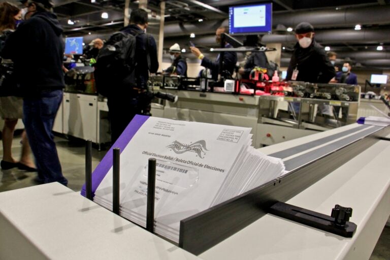 Addresses are printed on outgoing mail-in ballots at the Pennsylvania Convention Center. (Emma Lee/WHYY)