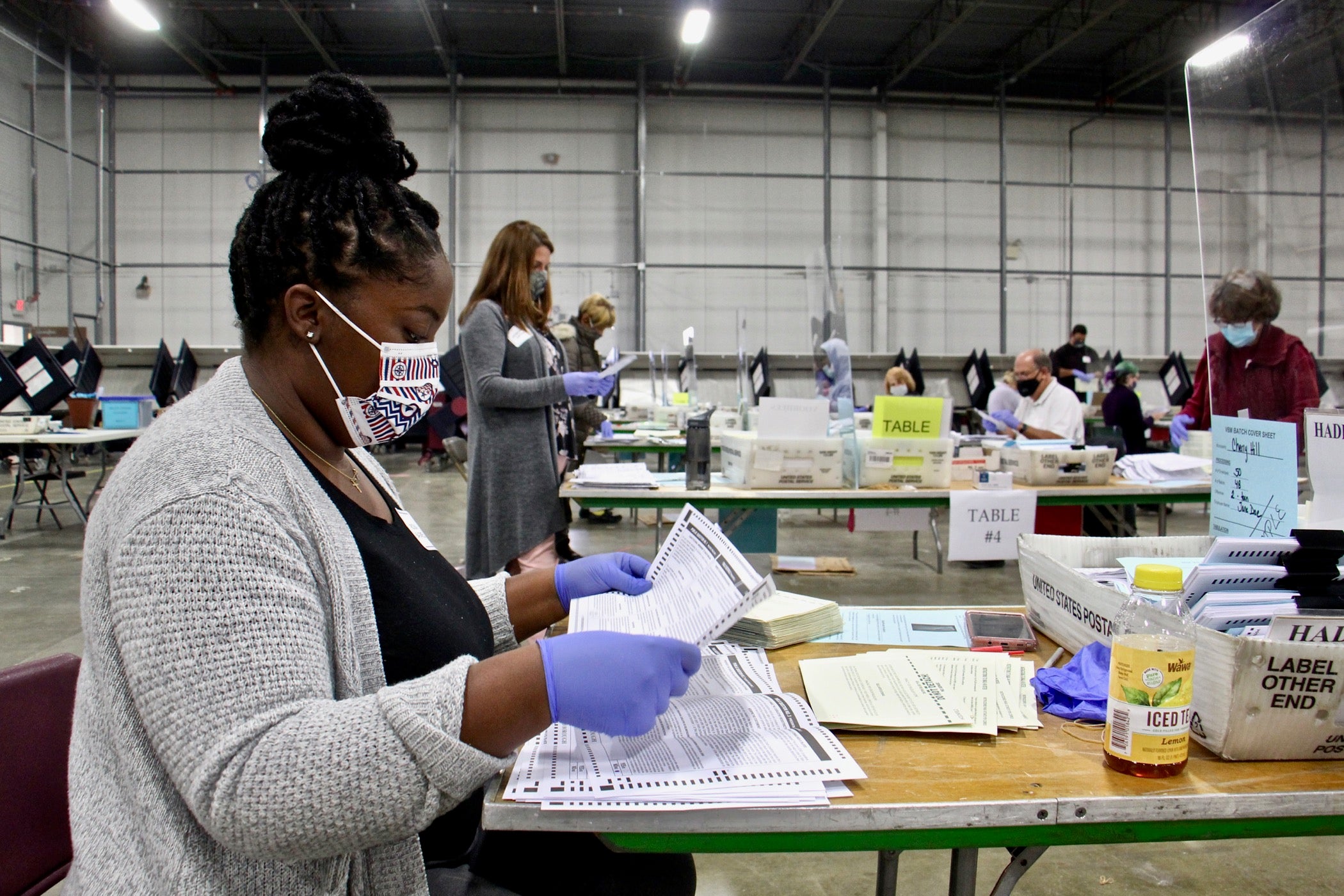 Rickia Bagwell of Lindenwold opens and inspects mail ballots