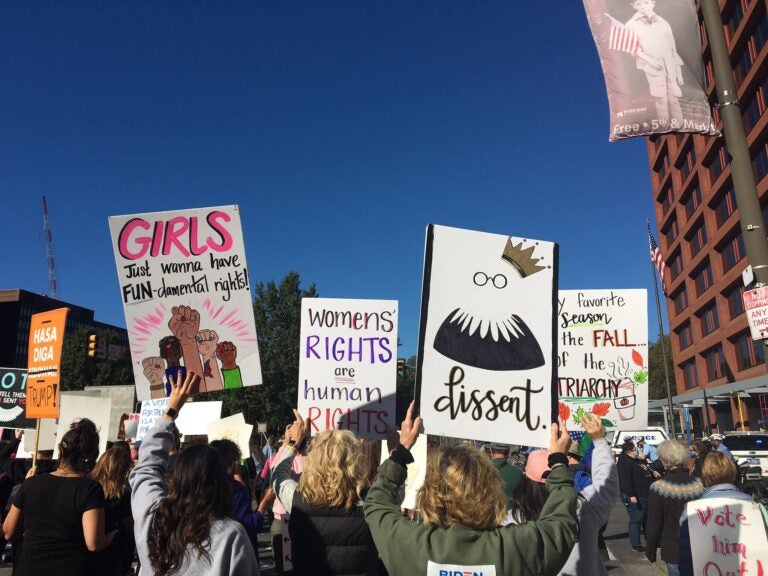 Signs reflect the sentiments of the crowd at Saturday's We Dissent women's march in Philadelphia. (Katie Meyer/WHYY)