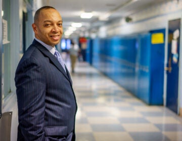 Richard Gordon, principal of Paul Robeson High School, in hallway with lockers