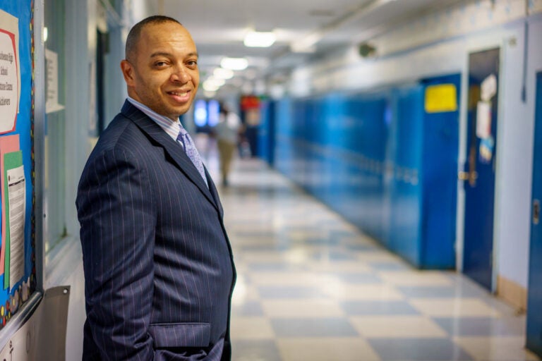 Richard Gordon, principal of Paul Robeson High School, in hallway with lockers
