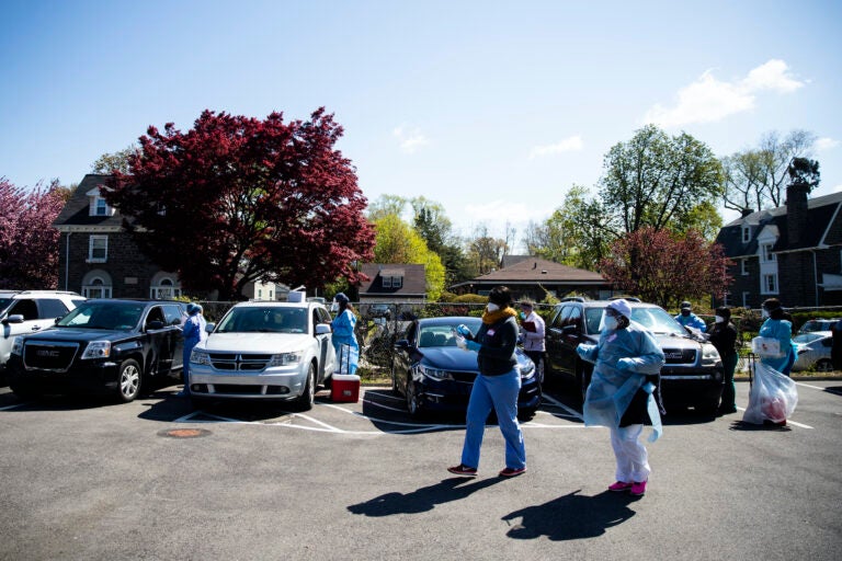 People in their vehicles receive COVID-19 tests at a barrier free location outside the Pinn Memorial Baptist Church in Philadelphia, Wednesday, April 22, 2020. (AP Photo/Matt Rourke)