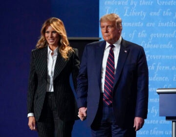 President Donald Trump and first lady Melania Trump hold hands on stage after the first presidential debate at Case Western University and Cleveland Clinic, in Cleveland, Ohio, Sept. 29, 2020. (AP Photo/Julio Cortez, File)